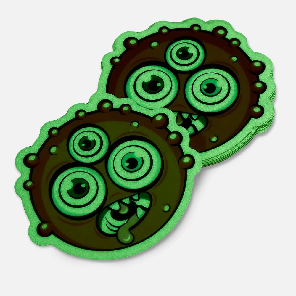 A stack of monster shaped glow in the dark stickers printed by StickerGiant