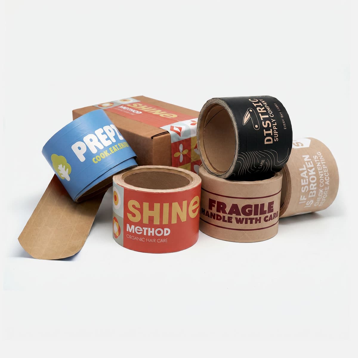 Custom packing tape rolls with branded designs displayed around a shipping box