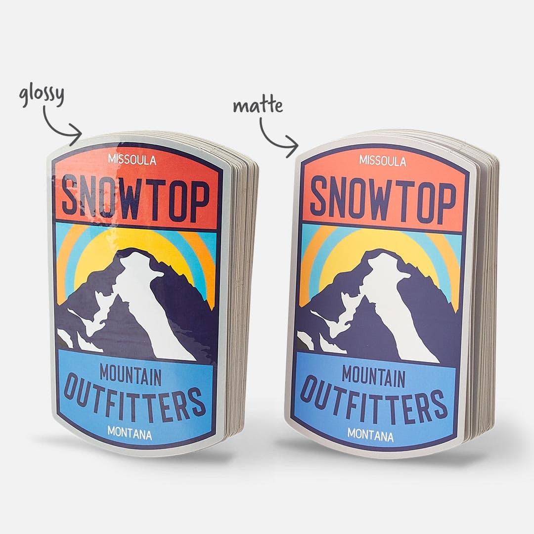 Side-by-side comparison of custom White BOPP stickers in glossy and matte finishes, featuring a Snowtop Mountain Outfitters design