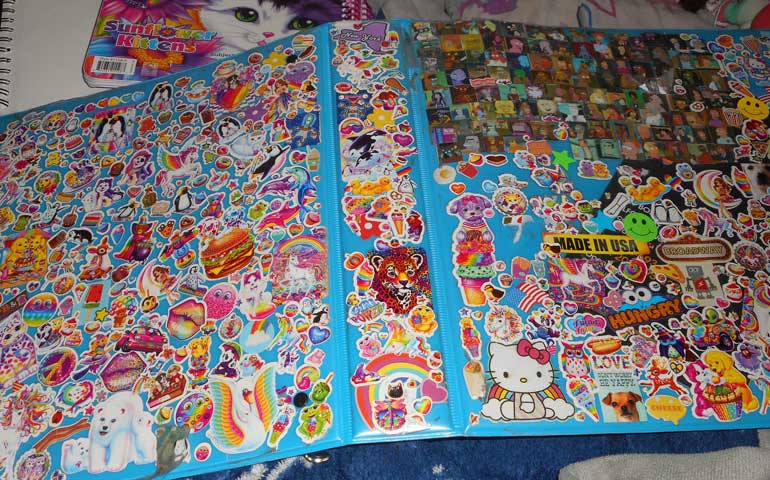 Image of Lisa Frank stickers on a binder for a StickerGiant blog