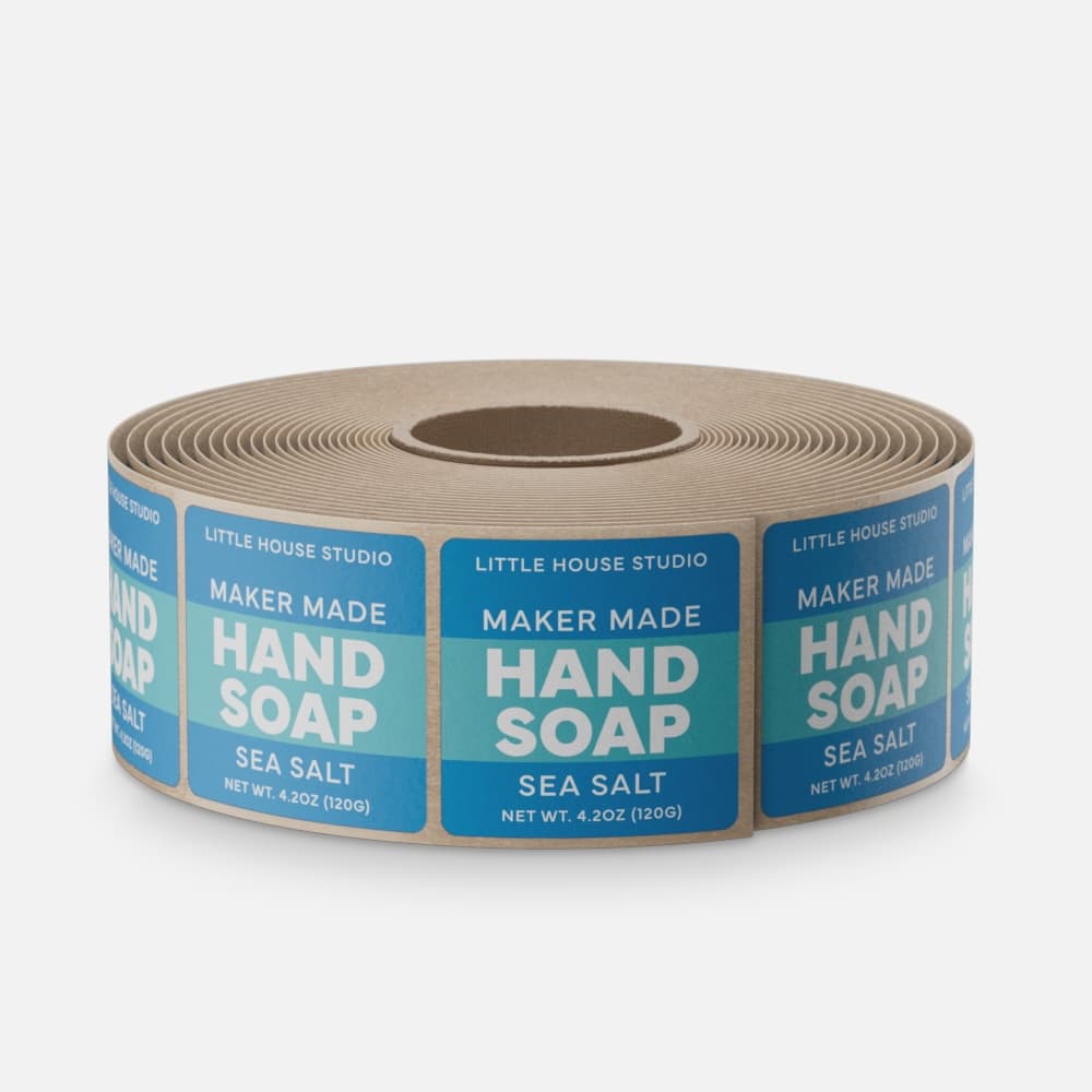Roll of custom matte paper hand soap labels with blue Maker Made branding.