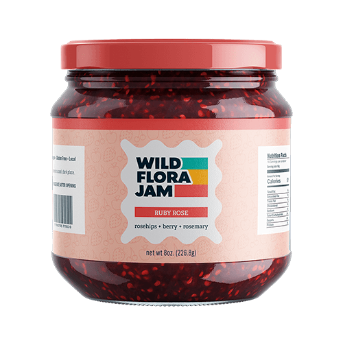 Jar of Wild Flora Jam (Ruby Rose flavor) with a custom printed label, showing product branding, ingredients, and nutrition panel on glass packaging
