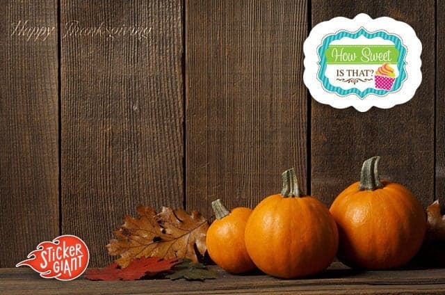 Three small pumpkins and autumn leaves arranged on a rustic wooden surface with a How Sweet Is That? custom shaped logo sticker displayed above and a StickerGiant logo in the corner.