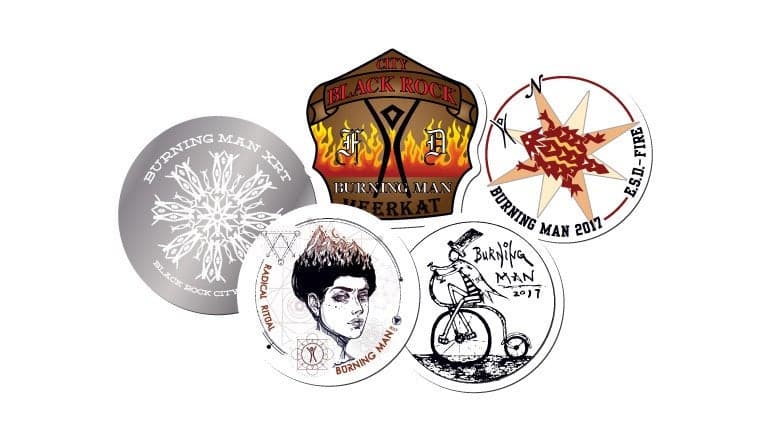 Collection of custom Burning Man stickers featuring artistic designs, symbols, and event inspired illustrations.
