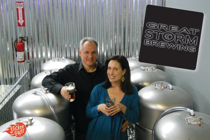 Owners of Great Storm Brewing Company with kegs and their custom sticker printed by StickerGiant