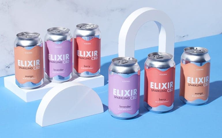 Elixir Sparkling CBD cans with custom labels arranged on white display props.