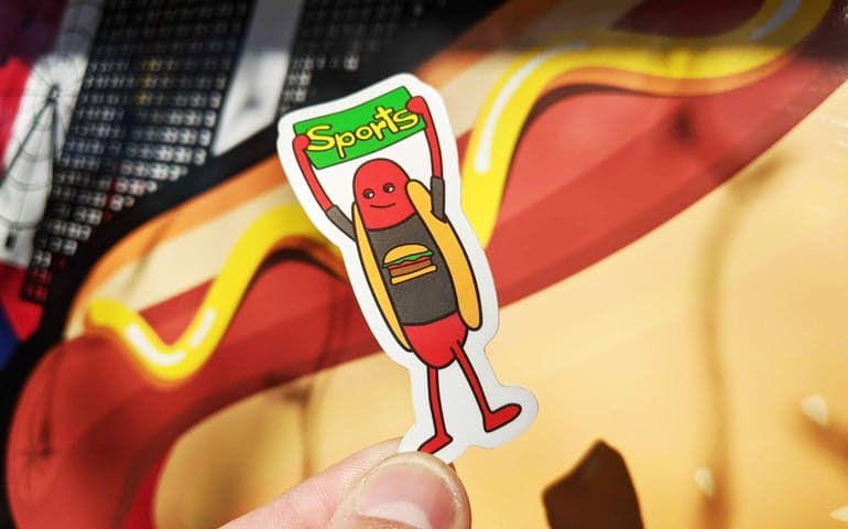 Die Cut Sticker of Hot Dog Holding Sports Sign for Haha Hot Dogs and Printed by StickerGiant